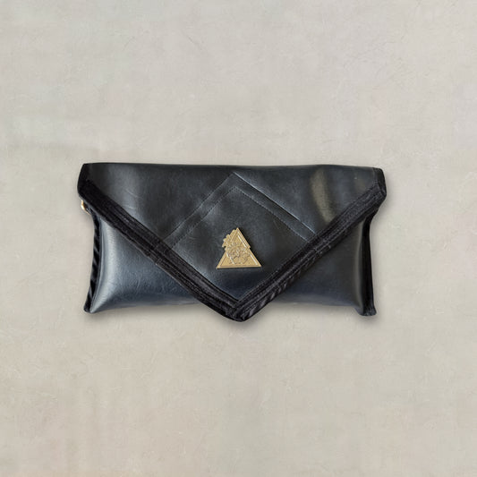 Luxury black Desserto cactus leather envelope clutch bag with structured silhouette and gold logo detail sustainable vegan handbag.