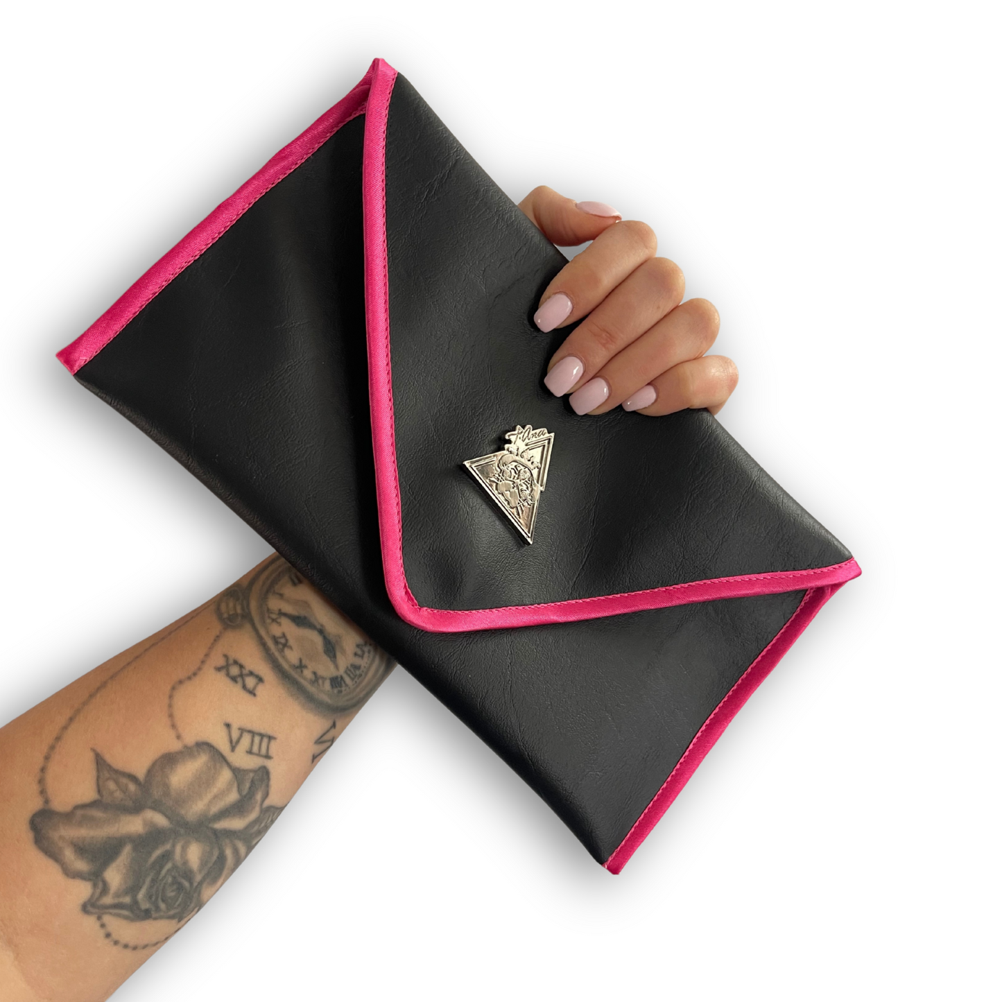 Black envelope clutch bag with pink trim and silver triangle logo; El Clásica Noire Rose clutch by t•Ana Couture displayed on a light background.