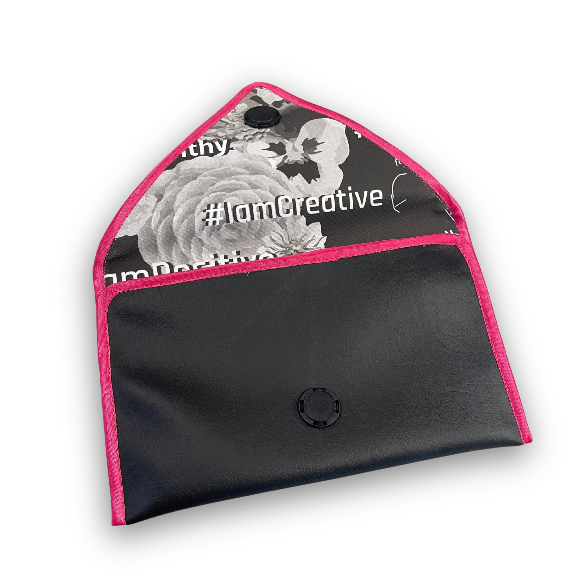 Black envelope clutch bag with pink trim and silver triangle logo; El Clásica Noire Rose clutch by t•Ana Couture displayed on a light background.