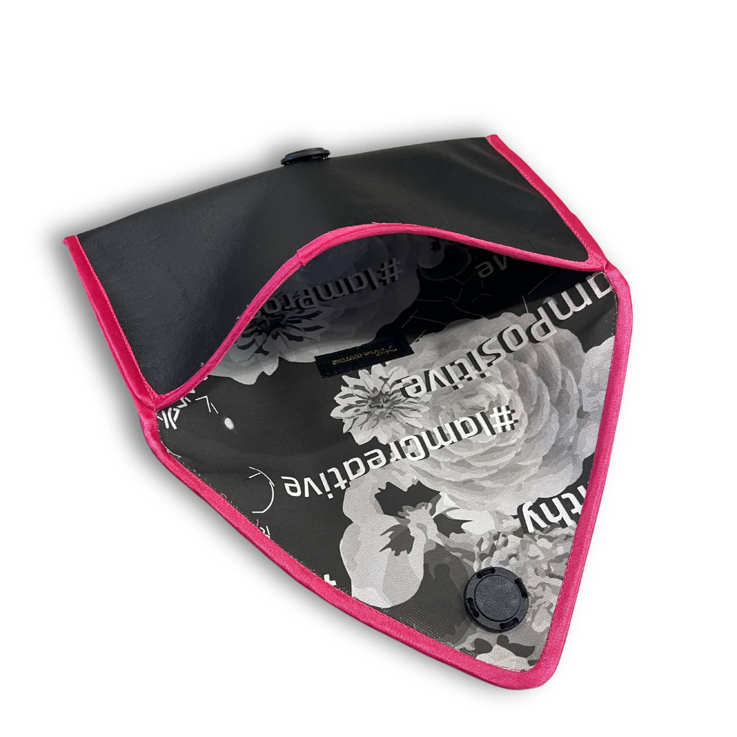 Black envelope clutch bag with pink trim and silver triangle logo; El Clásica Noire Rose clutch by t•Ana Couture displayed on a light background.