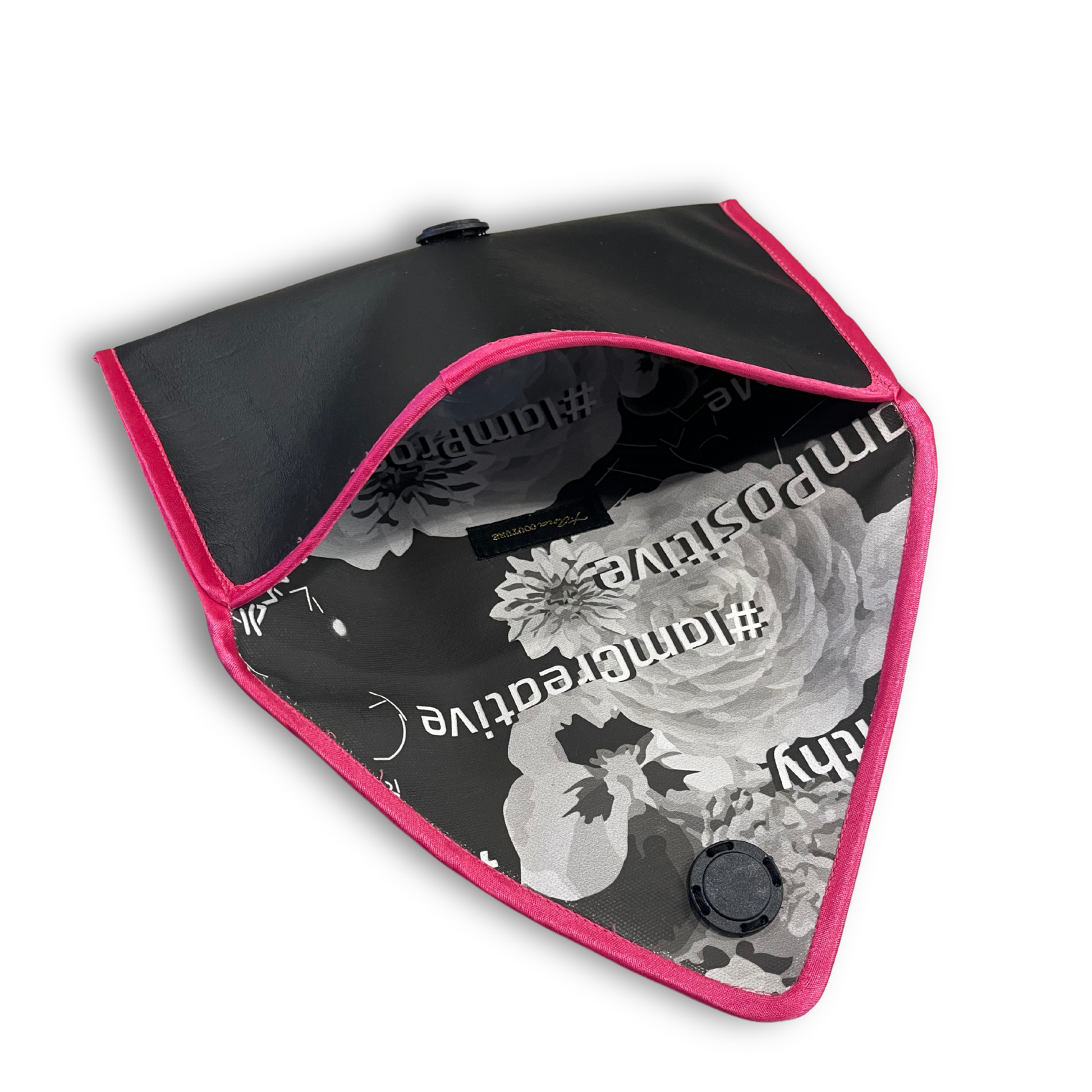 Black envelope clutch bag with pink trim and silver triangle logo; El Clásica Noire Rose clutch by t•Ana Couture displayed on a light background.