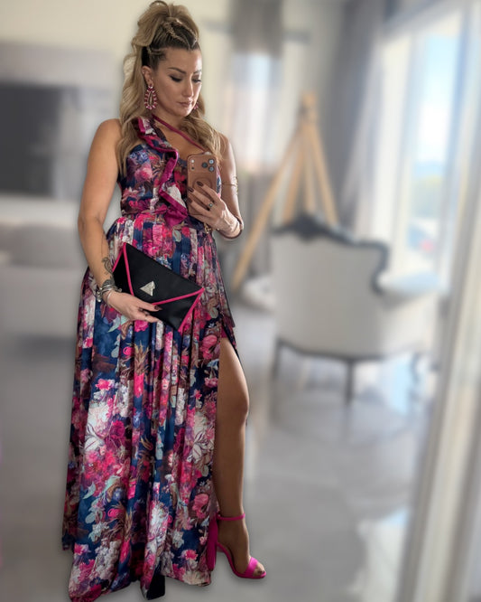 Exceptional designer floral couture two-piece set with ruffled top and maxi skirt by t•Ana Couture. Luxury three-piece floral satin couture set in blush and fuchsia tones by t•Ana Couture; captured under Mediterranean sunlight with divine flow and effortless elegance, in luxury house. Also holding a designer t•Ana Couture clutch bag. 