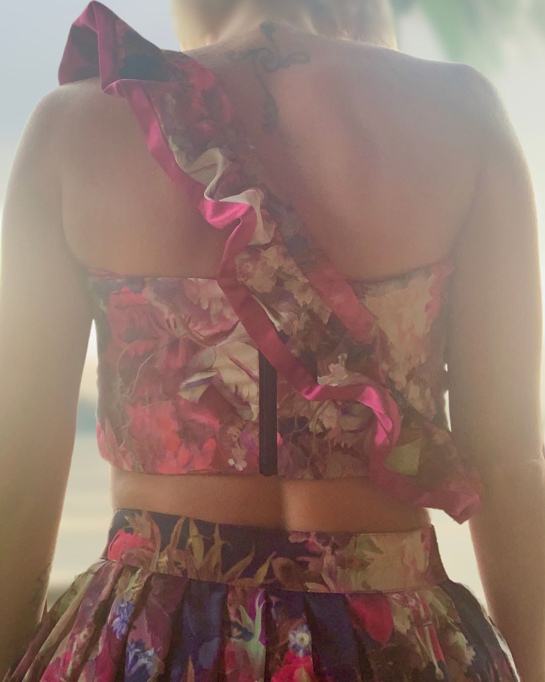 Luxury three-piece floral satin couture set in blush and fuchsia tones by t•Ana Couture; captured under Mediterranean sunlight with divine flow and effortless elegance. zip detail. Luxury island ambiance vibes.