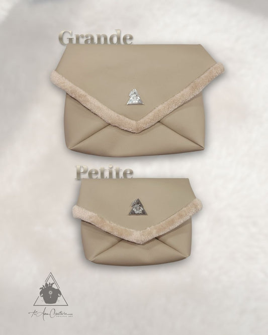 Amara Duo Sabbia beige vegan leather multi-wear clutch bags with silver logo plate; Grande and Petite sizes featuring plush faux-fur trim and interior from t•Ana Couture Eternal Bond Series
