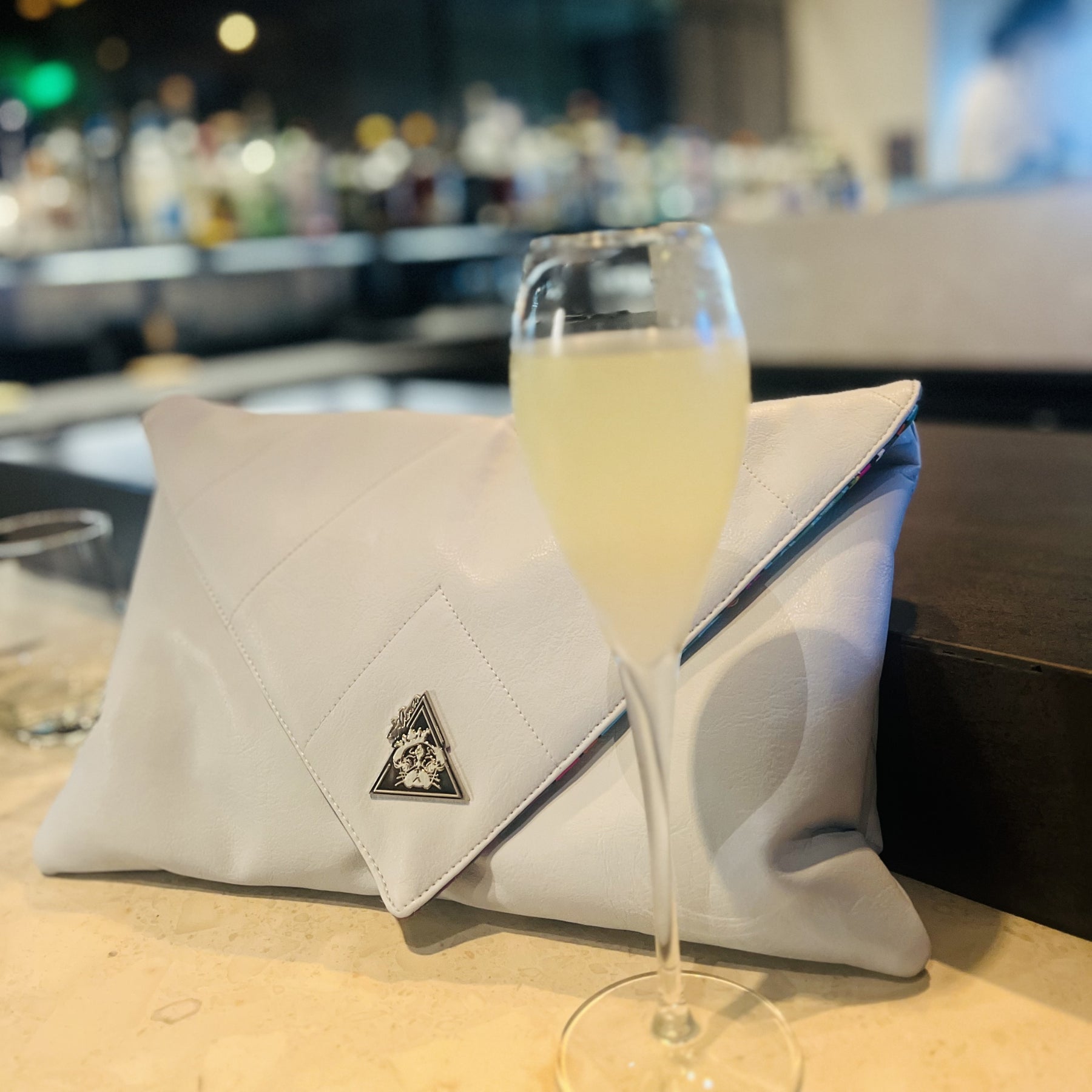 Anima Celeste oversized baby-blue clutch, styled view