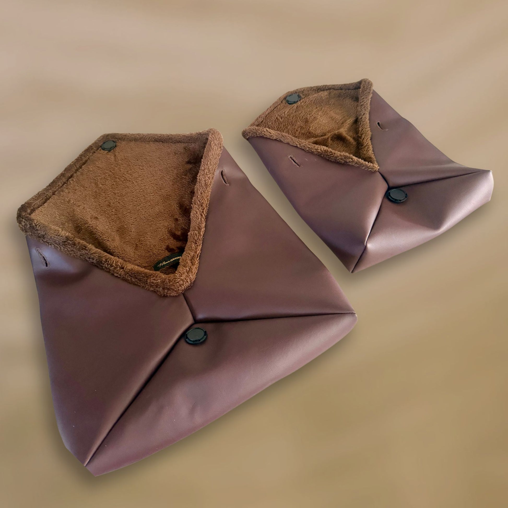 The Amara Duo from t•Ana Couture’s Chocolate Edit features two luxury multi wear clutch bags; one Grande and one Petite; designed to be worn together or individually. Crafted in plush chocolate brown faux fur and finished with gold logo hardware, the Amara bags bring warmth, texture and refined slow luxury to any look. Each piece can be styled as a clutch, shoulder bag or crossbody, offering versatile day to evening wear. Here we are featuring the interior of the bags with the faux fur. 