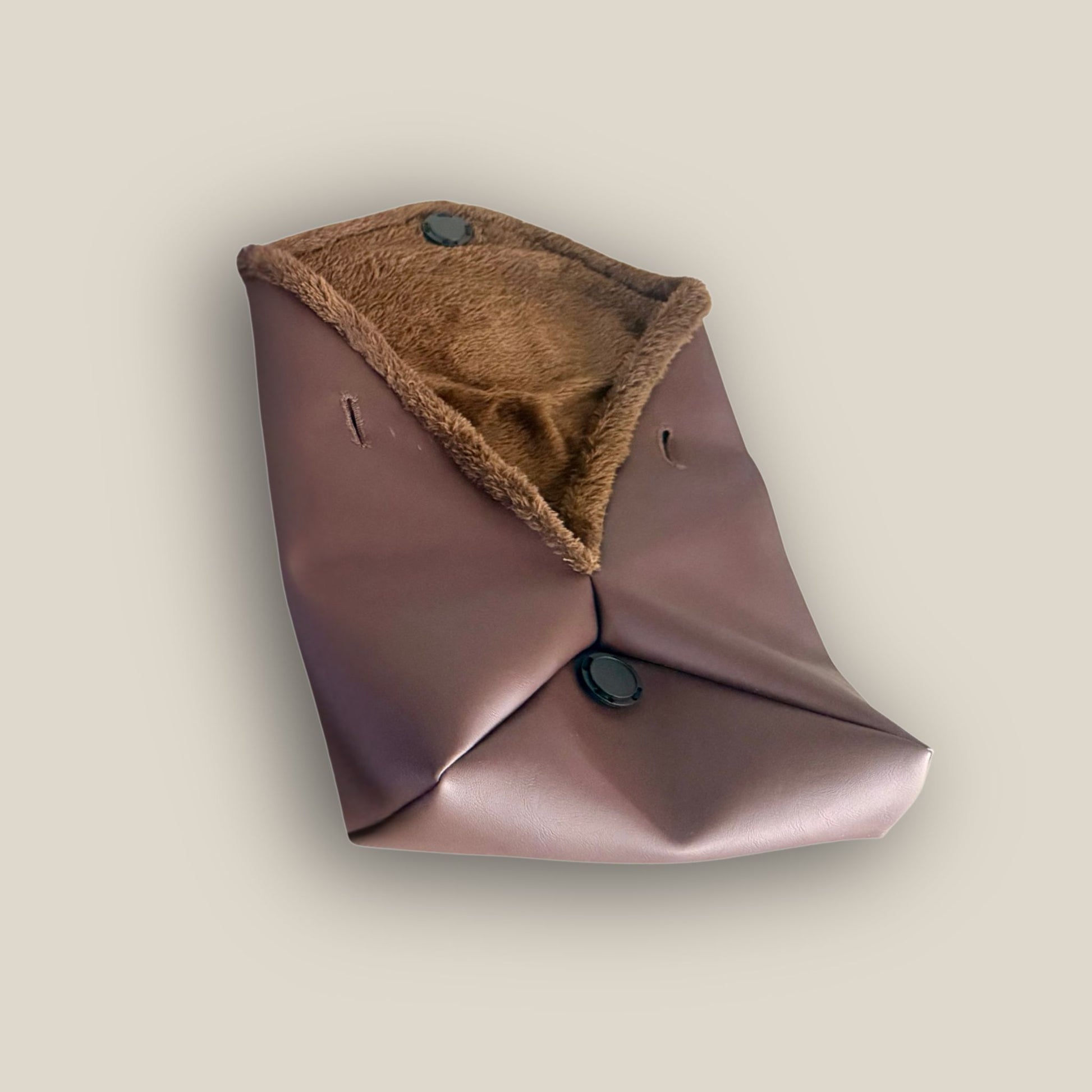 The Amara petite small brown bag from t•Ana Couture’s Chocolate Edit from the Amara Duo. Crafted in plush chocolate brown faux fur and finished with gold logo hardware, the Amara bags bring warmth, texture and refined slow luxury to any look. Each piece can be styled as a clutch, shoulder bag or crossbody, offering versatile day to evening wear. Here we feature the petite or small size bag.