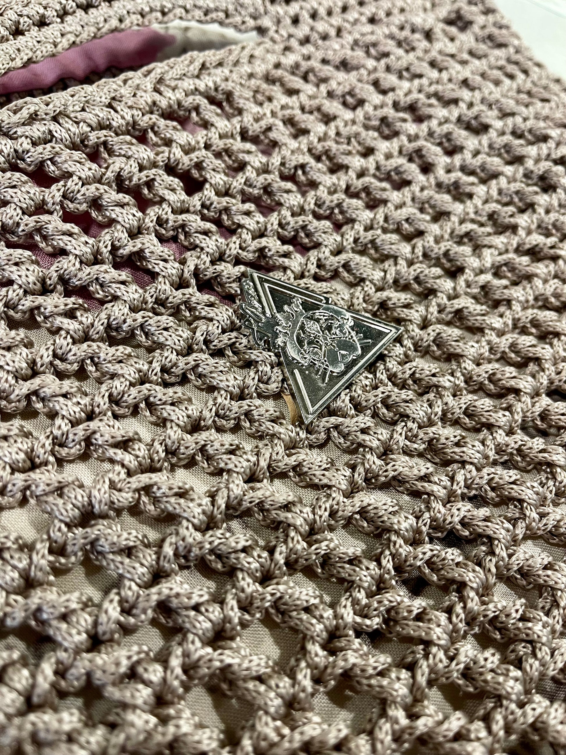 Silver metal t.Ana Couture logo hardware on Mystic Mocha Bloom hand knit mocha handbag from Mediterranean Muse Sand and Sea Collection
