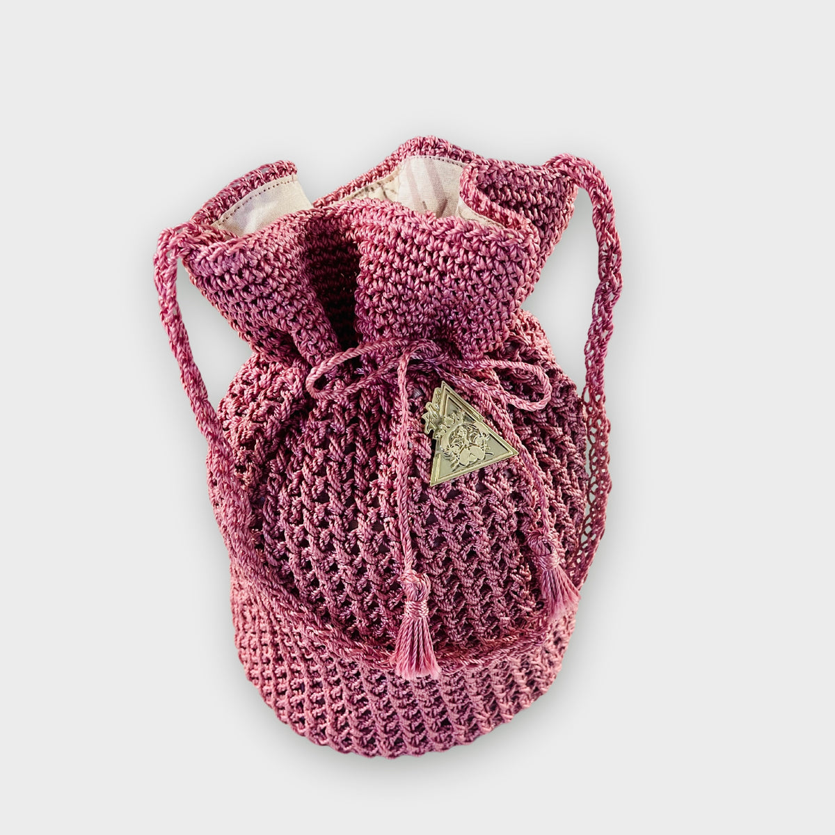 Rosa Magica pink hand-knit bag, styled view
