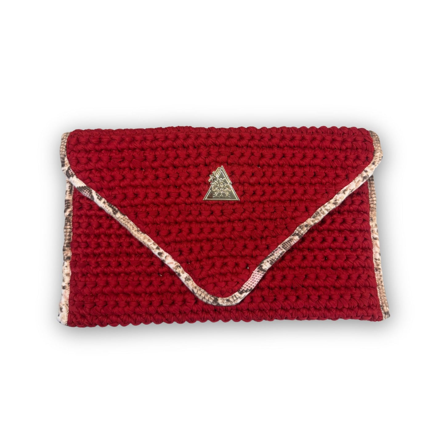 Sacred Venom Magenta Knit Clutch Handbag – magenta red knit clutch with gold logo and beige snake-print lining from t•Ana Couture’s Mediterranean Muse: Sand & Sea Collection; symbolizing passion, transformation, and divine feminine grace.