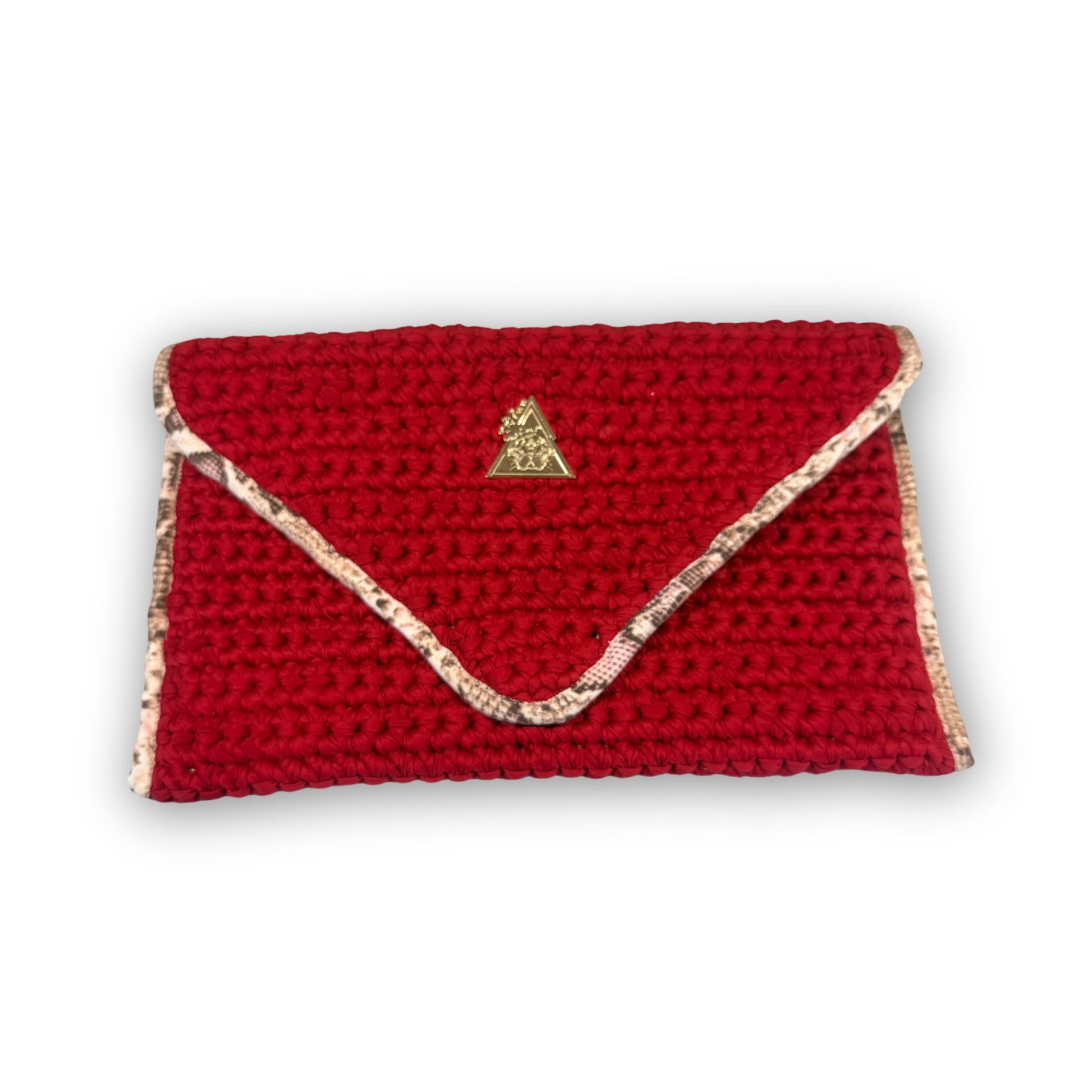 Sacred Venom Magenta Knit Clutch Handbag – magenta red knit clutch with gold logo and beige snake-print lining from t•Ana Couture’s Mediterranean Muse: Sand & Sea Collection; symbolizing passion, transformation, and divine feminine grace.