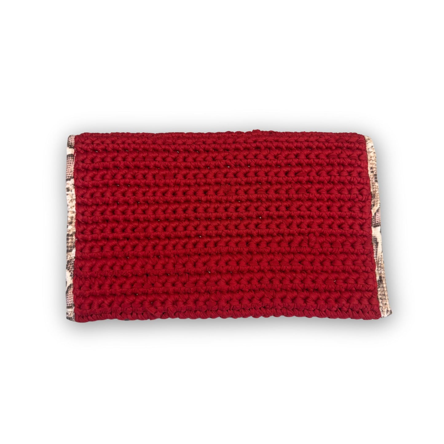 Sacred Venom Magenta Knit Clutch Handbag – magenta red knit clutch with gold logo and beige snake-print lining from t•Ana Couture’s Mediterranean Muse: Sand & Sea Collection; symbolizing passion, transformation, and divine feminine grace.