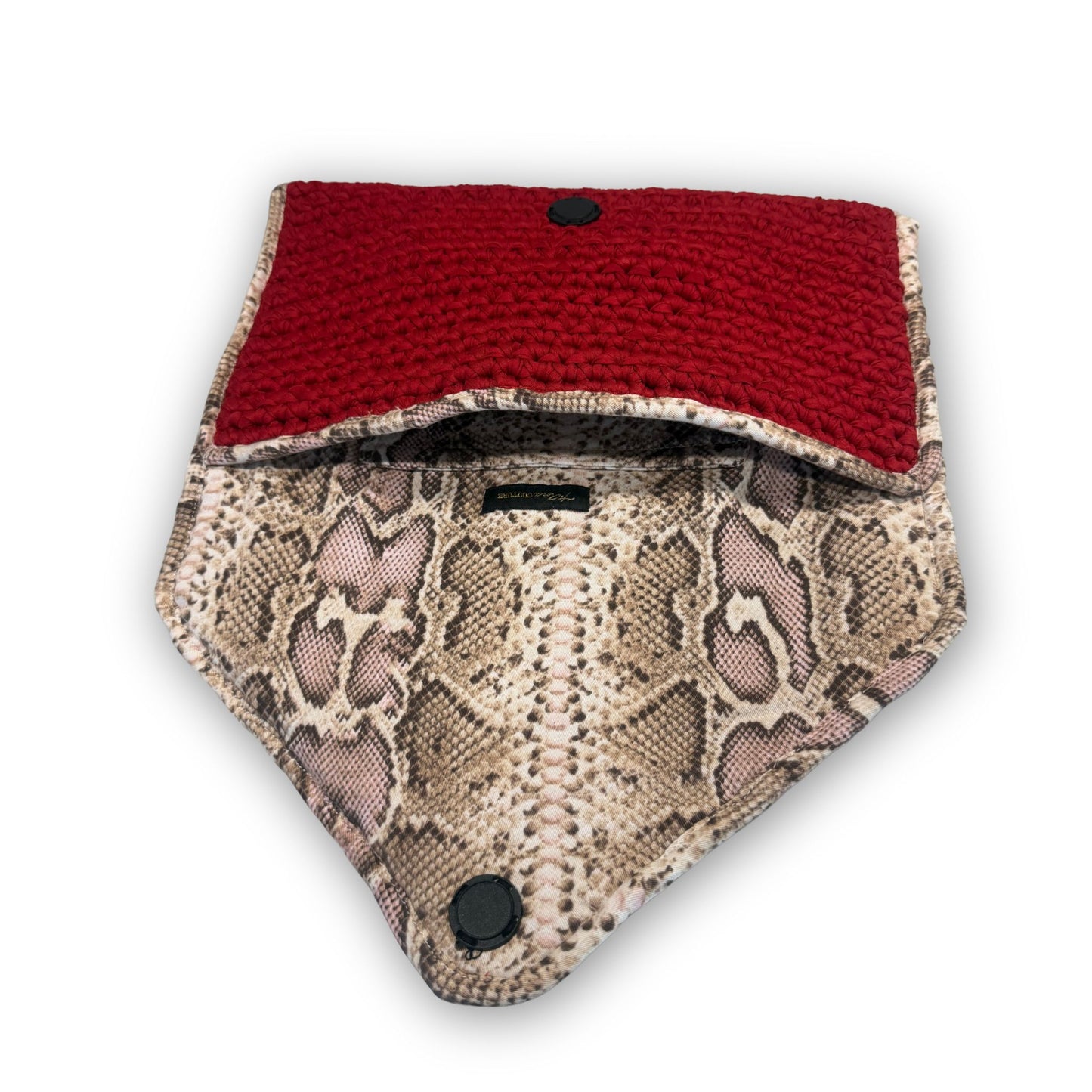 Sacred Venom Magenta Knit Clutch Handbag – magenta red knit clutch with gold logo and beige snake-print lining from t•Ana Couture’s Mediterranean Muse: Sand & Sea Collection; symbolizing passion, transformation, and divine feminine grace.