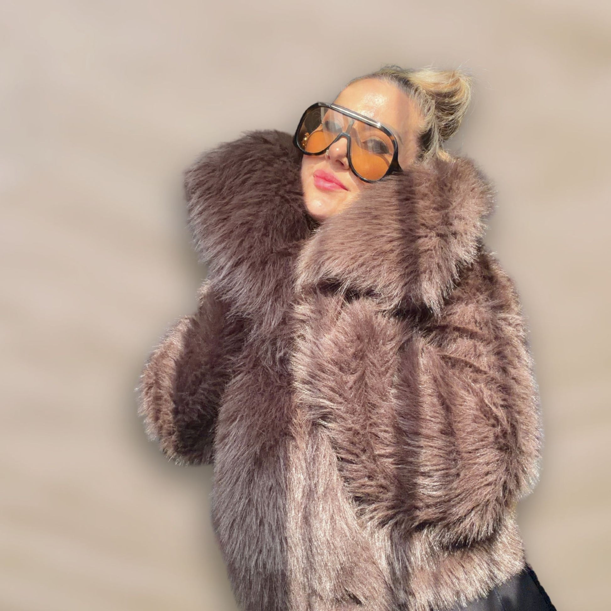 Soft brown faux fur coat featuring natural wooden buttons and practical pockets; a plush, cosy and elegant neutral outerwear piece for women, designed for slow luxury winter styling and refined day to evening looks. This warm, timeless coat elevates everyday outfits with texture, comfort and effortless sophistication.