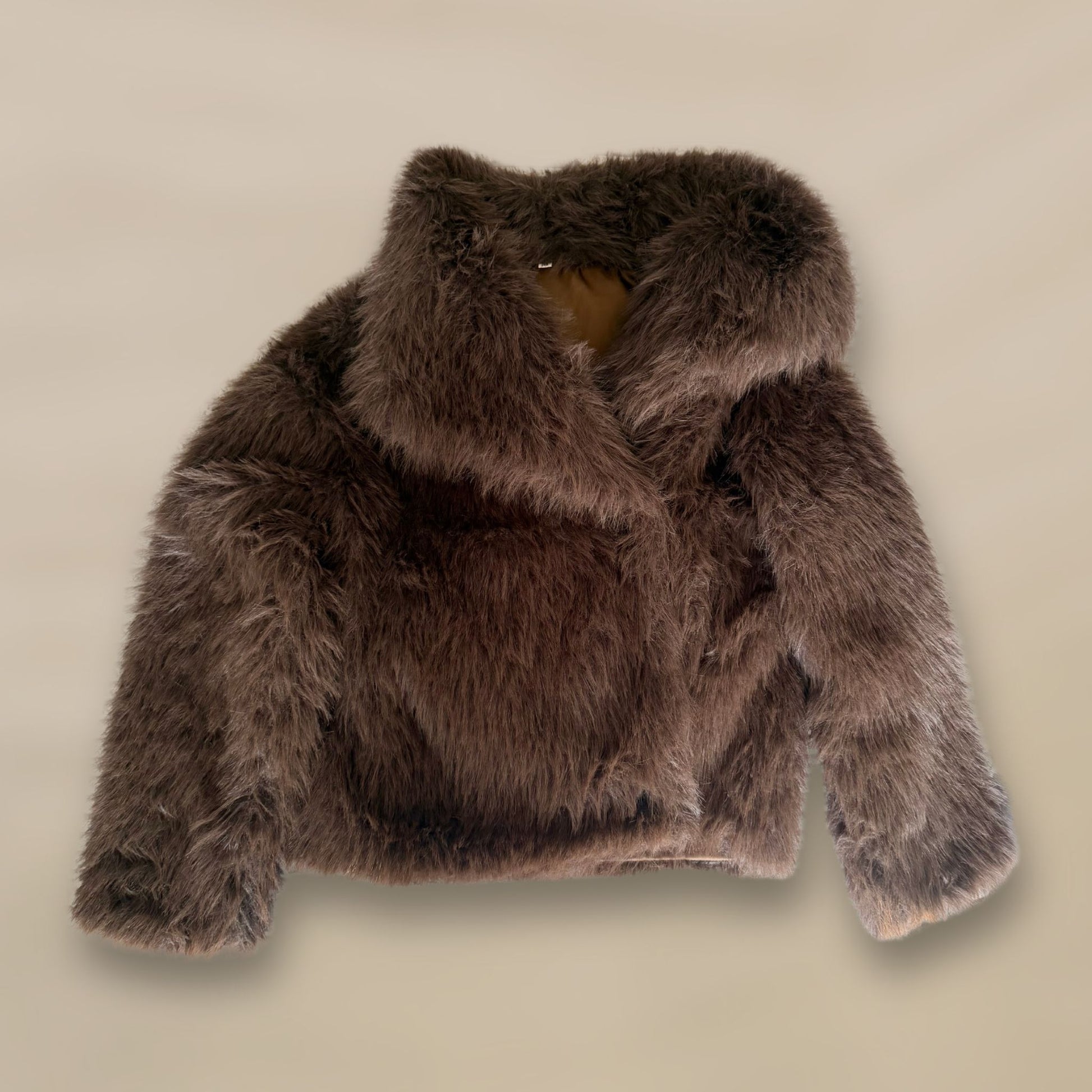 Soft brown faux fur coat featuring natural wooden buttons and practical pockets; a plush, cosy and elegant neutral outerwear piece for women, designed for slow luxury winter styling and refined day to evening looks. This warm, timeless coat elevates everyday outfits with texture, comfort and effortless sophistication.