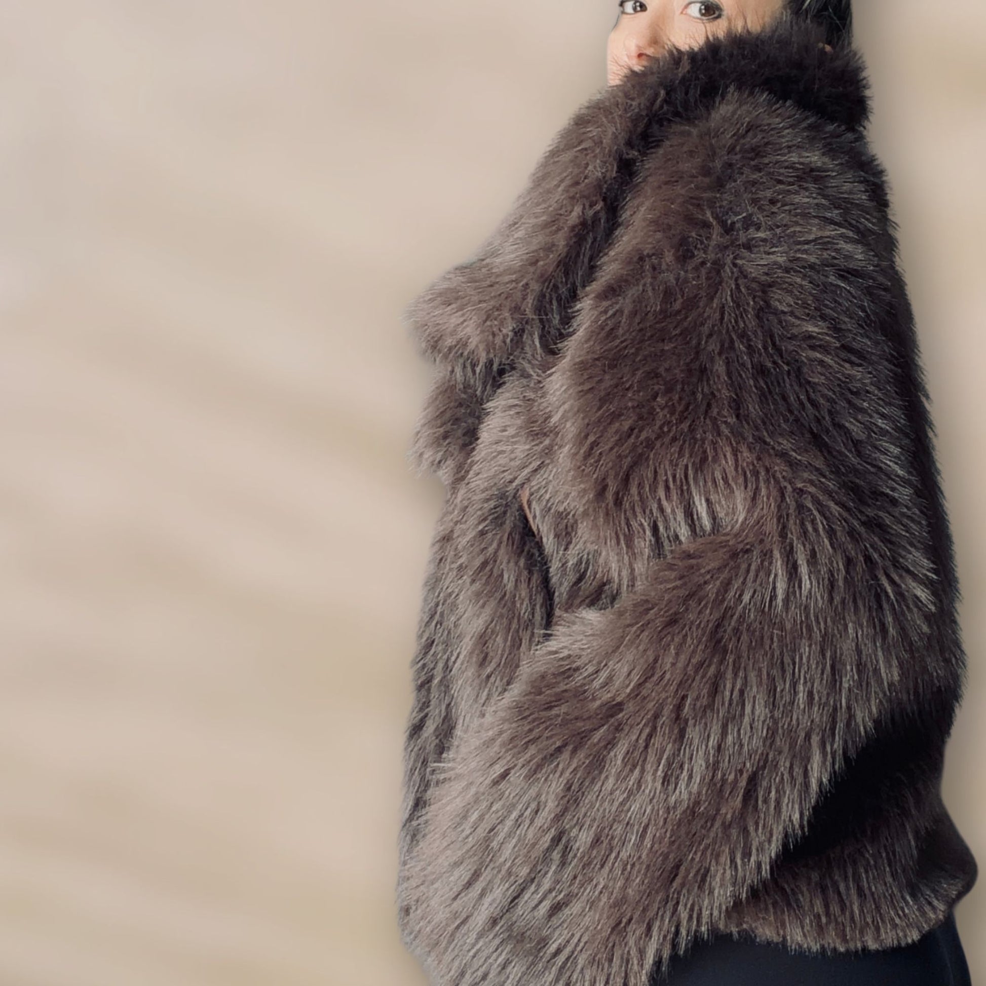Soft brown faux fur coat featuring natural wooden buttons and practical pockets; a plush, cosy and elegant neutral outerwear piece for women, designed for slow luxury winter styling and refined day to evening looks. This warm, timeless coat elevates everyday outfits with texture, comfort and effortless sophistication.
