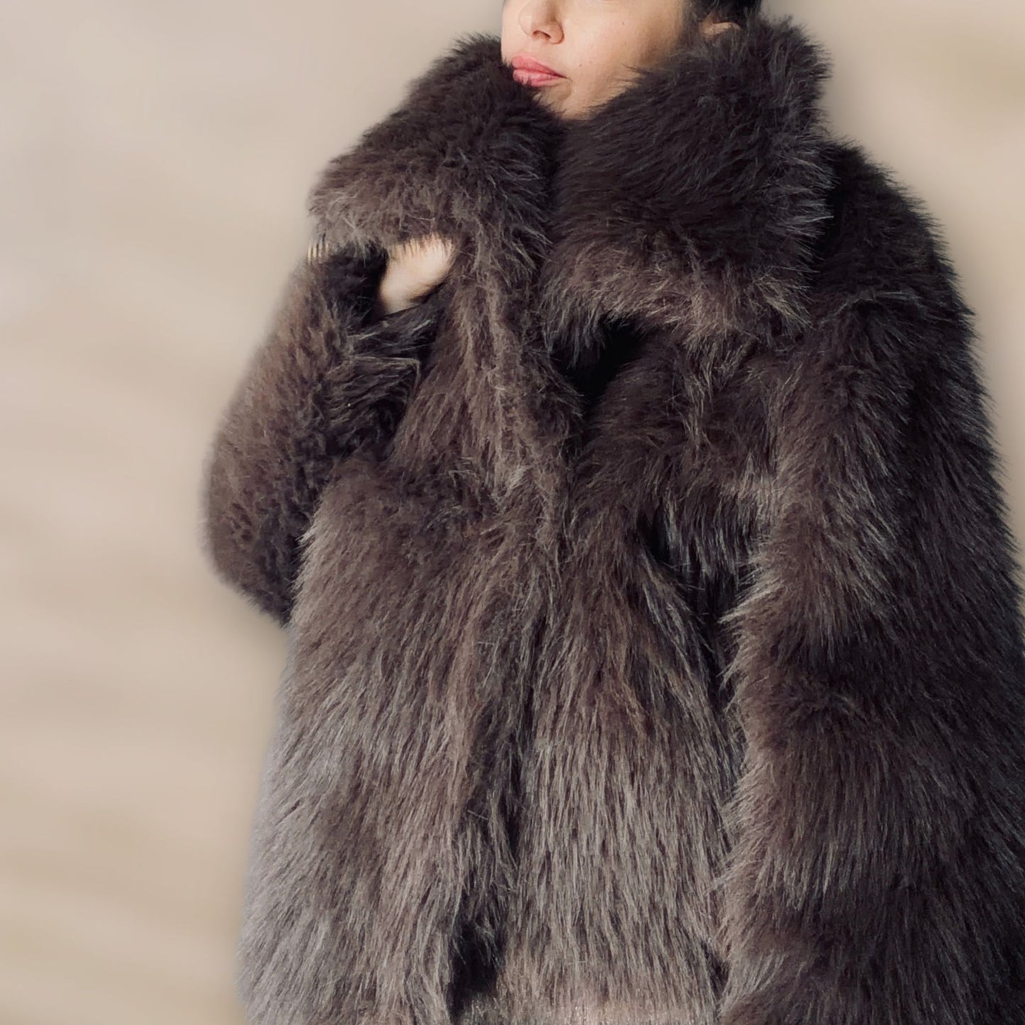 Soft brown faux fur coat featuring natural wooden buttons and practical pockets; a plush, cosy and elegant neutral outerwear piece for women, designed for slow luxury winter styling and refined day to evening looks. This warm, timeless coat elevates everyday outfits with texture, comfort and effortless sophistication.