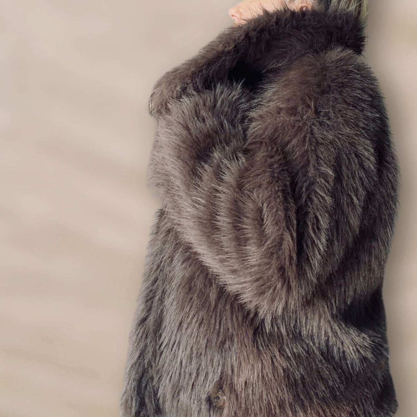 Soft brown faux fur coat featuring natural wooden buttons and practical pockets; a plush, cosy and elegant neutral outerwear piece for women, designed for slow luxury winter styling and refined day to evening looks. This warm, timeless coat elevates everyday outfits with texture, comfort and effortless sophistication.