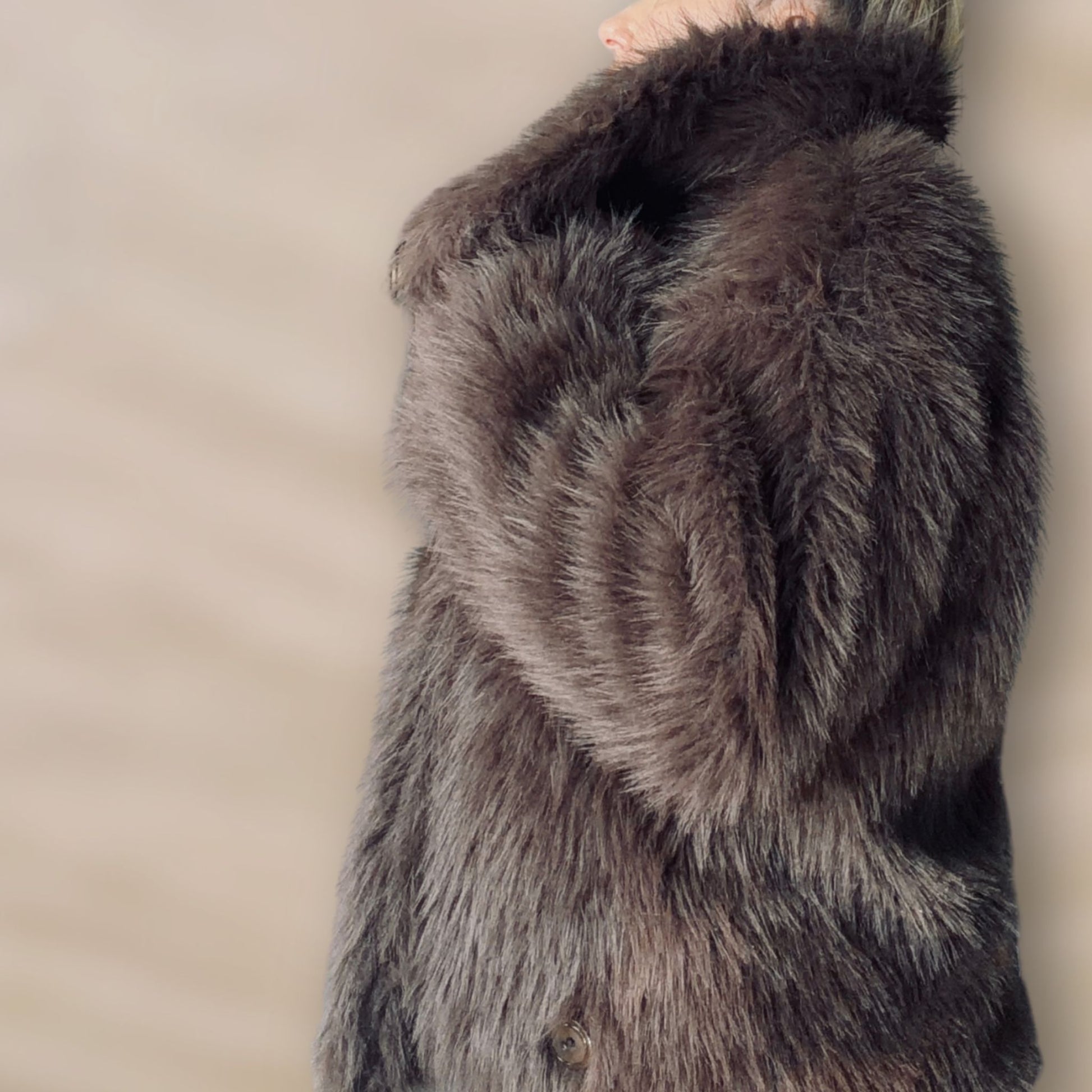 Soft brown faux fur coat featuring natural wooden buttons and practical pockets; a plush, cosy and elegant neutral outerwear piece for women, designed for slow luxury winter styling and refined day to evening looks. This warm, timeless coat elevates everyday outfits with texture, comfort and effortless sophistication.