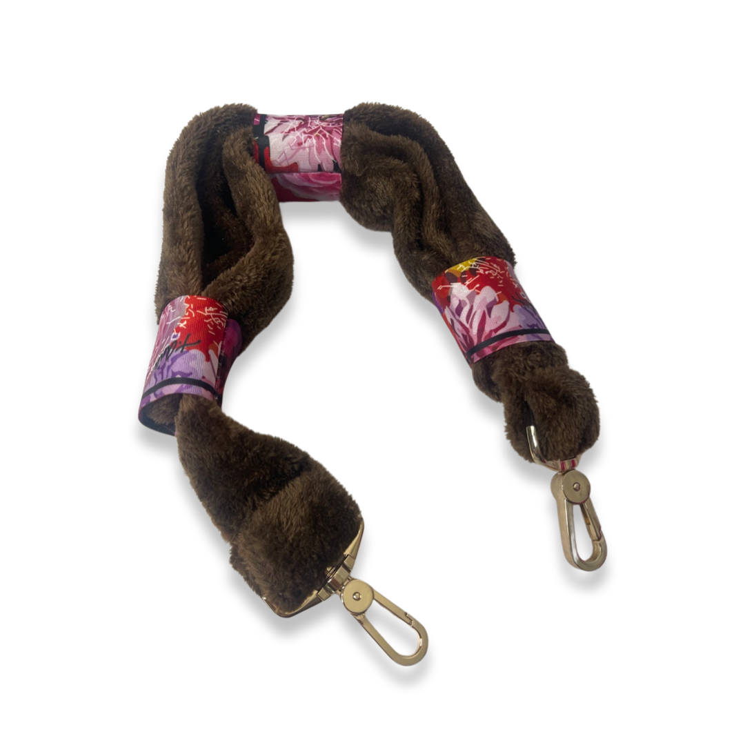 t•Ana Couture LA SnugglePlush Elegante handbag in brown faux fur with bold pink plush trim and LA lettering; luxury statement clutch styled with cream coat; sustainable upcycled design with modern street-luxe elegance.