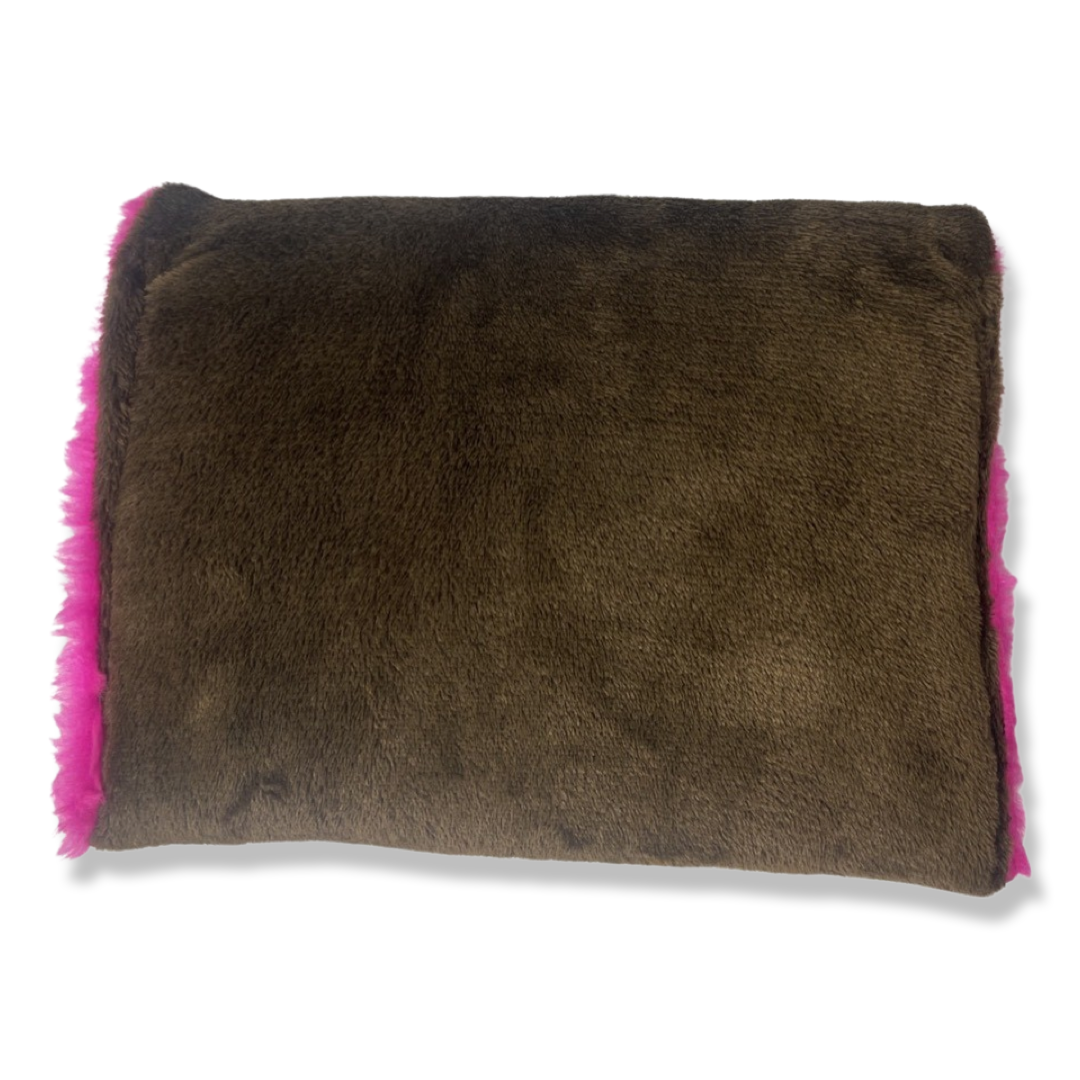 t•Ana Couture LA SnugglePlush Elegante handbag in brown faux fur with bold pink plush trim and LA lettering; luxury statement clutch styled with cream coat; sustainable upcycled design with modern street-luxe elegance.