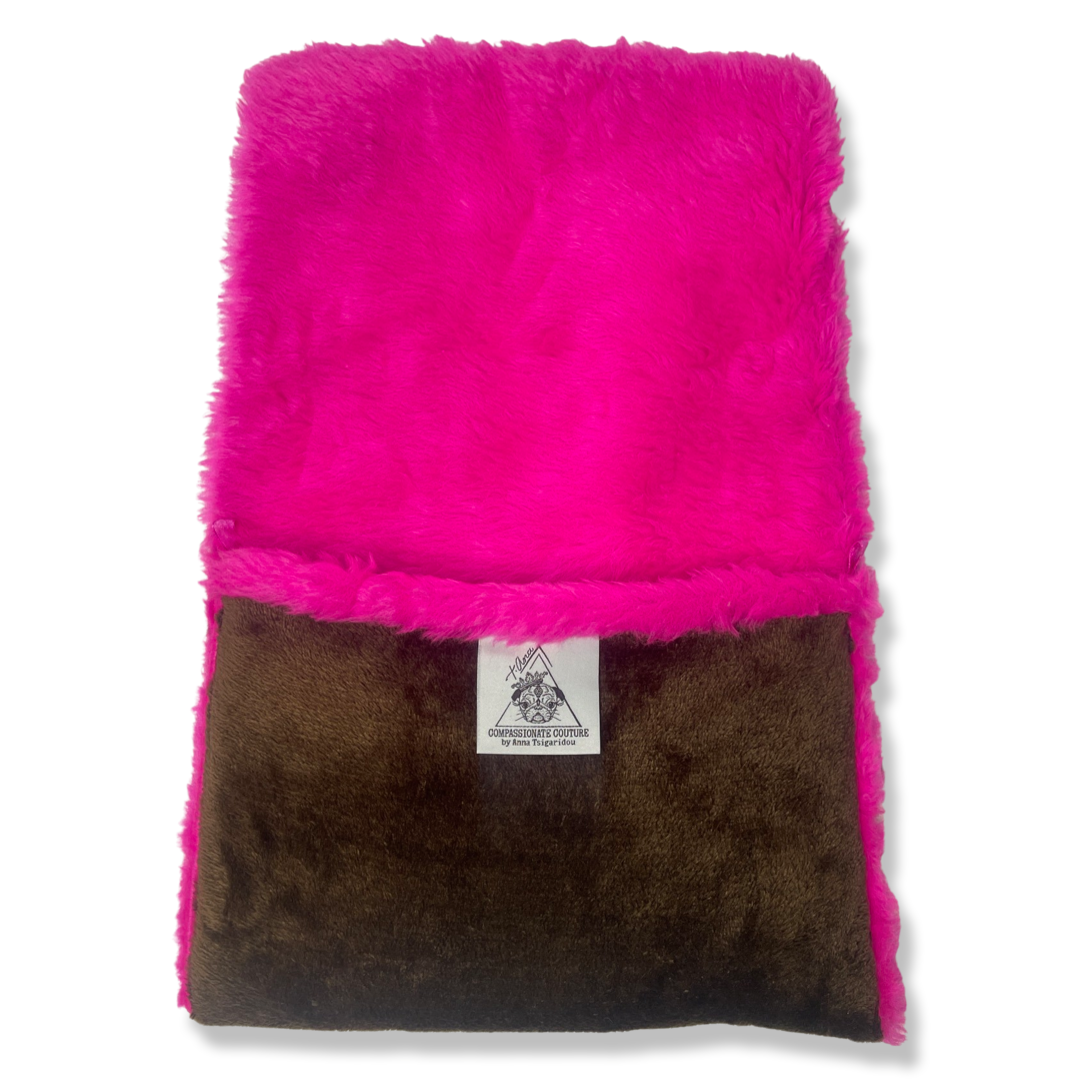 t•Ana Couture LA SnugglePlush Elegante handbag in brown faux fur with bold pink plush trim and LA lettering; luxury statement clutch styled with cream coat; sustainable upcycled design with modern street-luxe elegance.