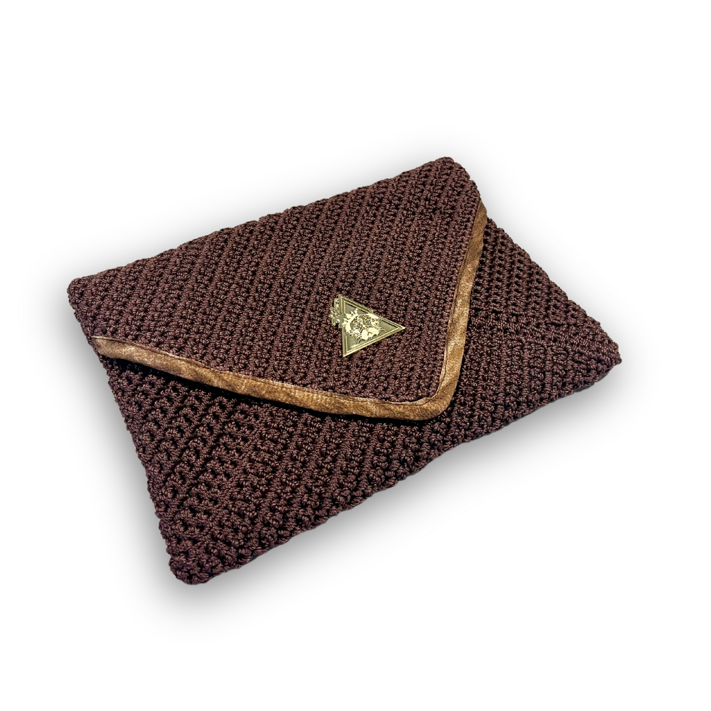 t•Ana Couture Terra Litha Knit Clutch Handbag in rich earthy brown with gold velvet trim and tiger-print interior lining; handmade luxury knit bag styled with brown coat; sustainable, Mediterranean-inspired design. Exceptional luxury design handbag. Elevated luxury brand vibes for high value women.
