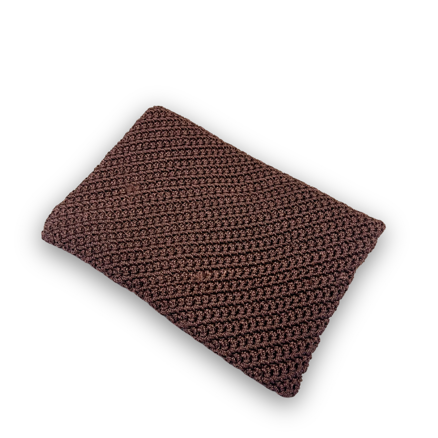 t•Ana Couture Terra Litha Knit Clutch Handbag in rich earthy brown with gold velvet trim and tiger-print interior lining; handmade luxury knit bag styled with brown coat; sustainable, Mediterranean-inspired design. Exceptional luxury design handbag. Elevated luxury brand vibes for high value women.