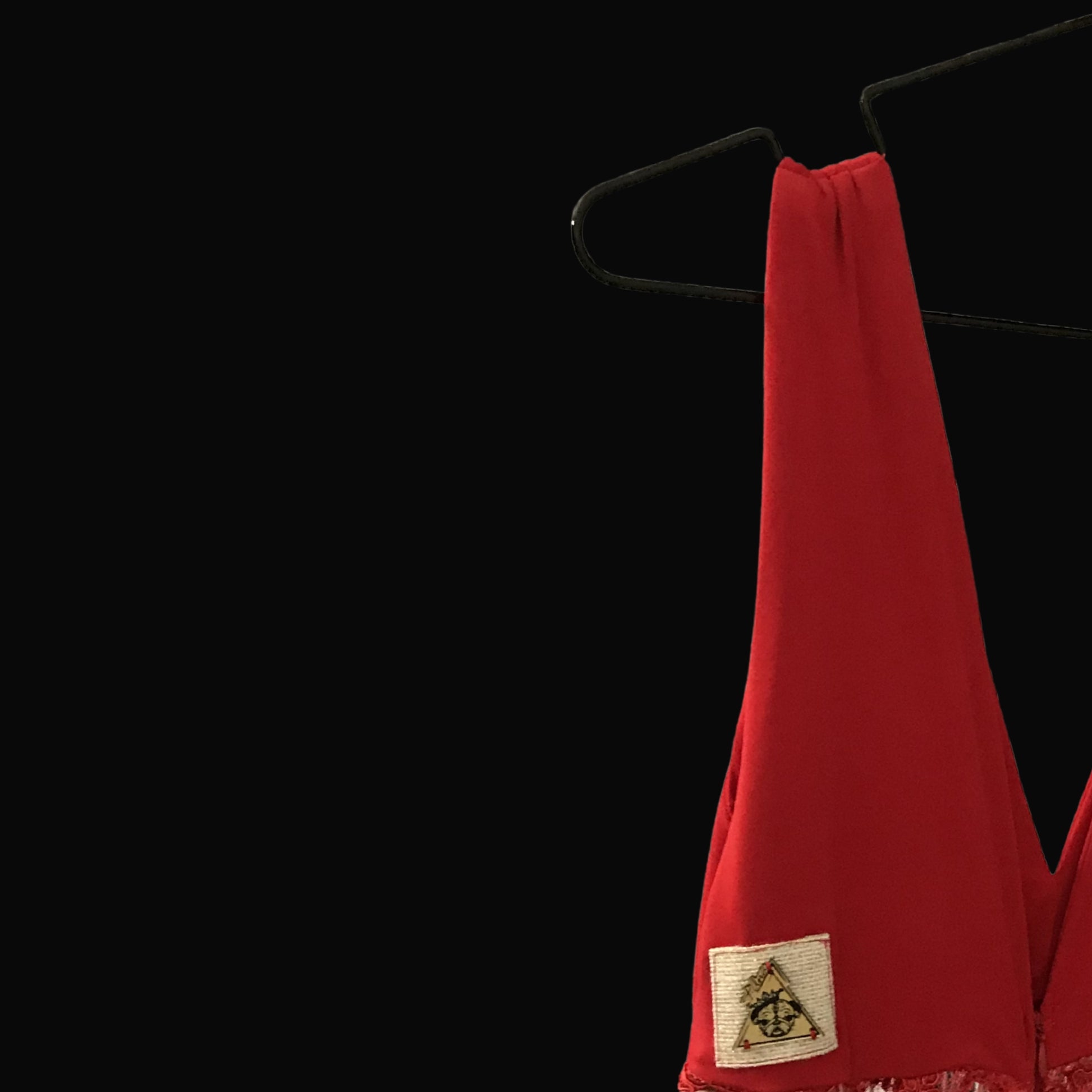 Red garment with a brand logo on a black background