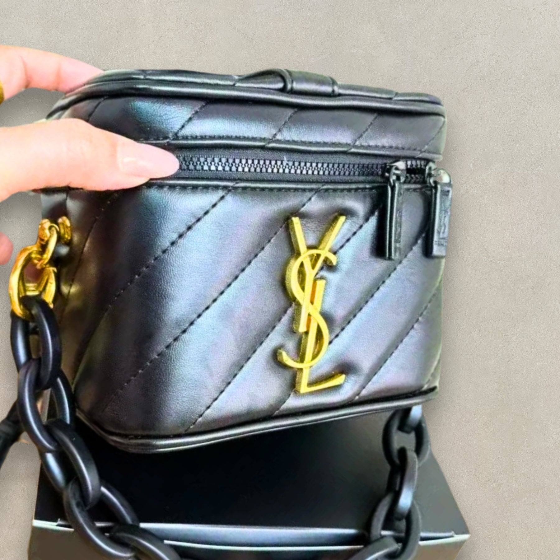 YSL Beauté VIP gold vanity bag, styled view