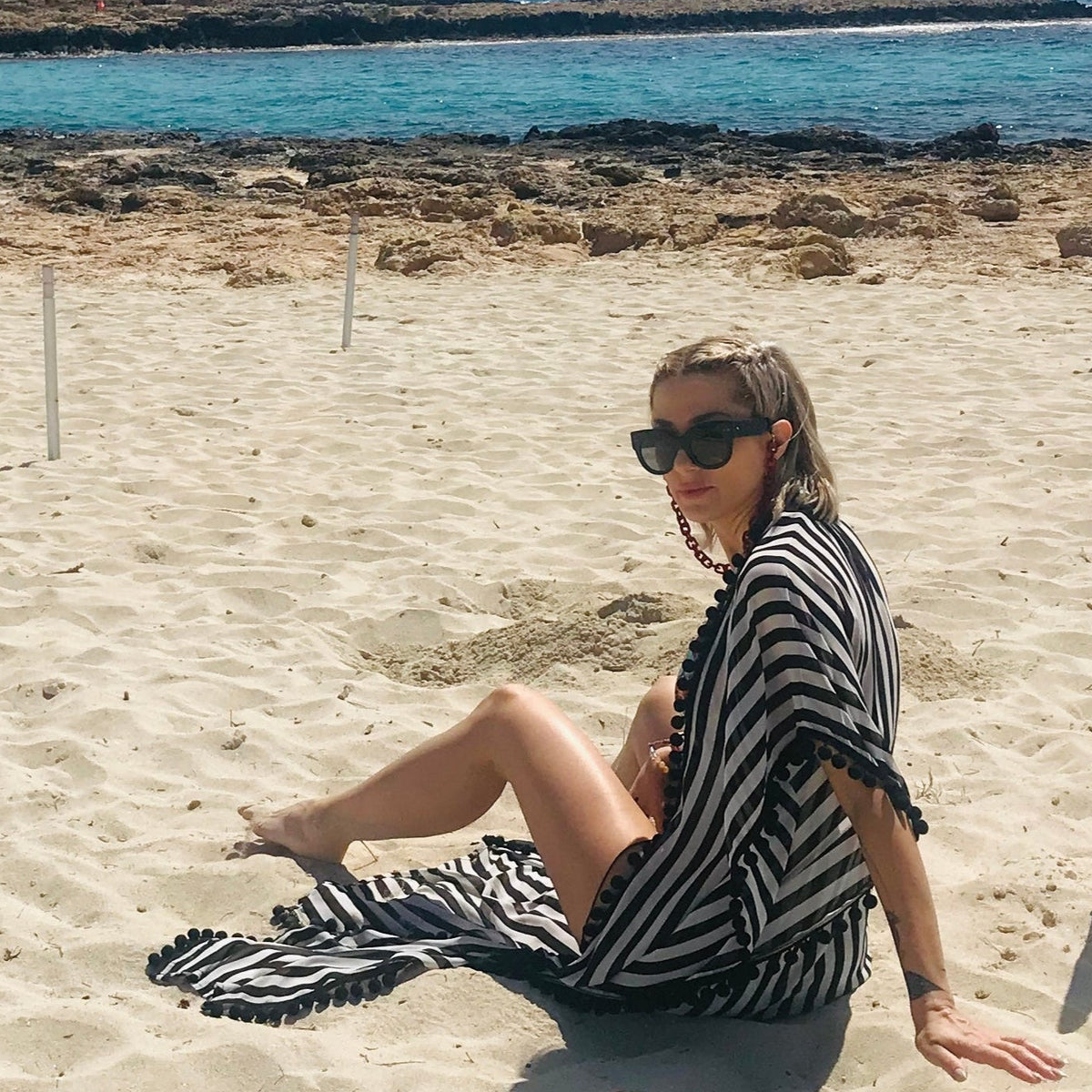 Utopia black and white semi-sheer caftan with black pom-poms